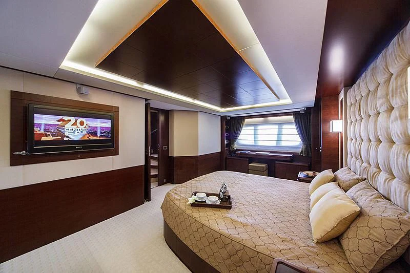 a hotel room with a bed and a tv aboard TARTARUGA ONE 4J'S Yacht for Sale