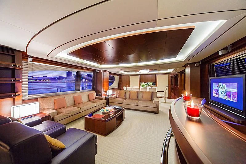 a living room with a large screen aboard TARTARUGA ONE 4J'S Yacht for Sale