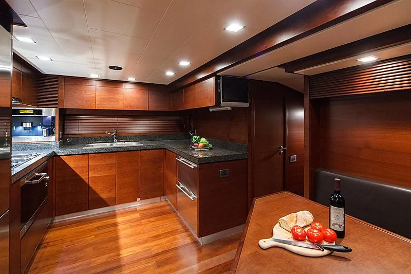 a kitchen with wooden cabinets aboard TARTARUGA ONE 4J'S Yacht for Sale