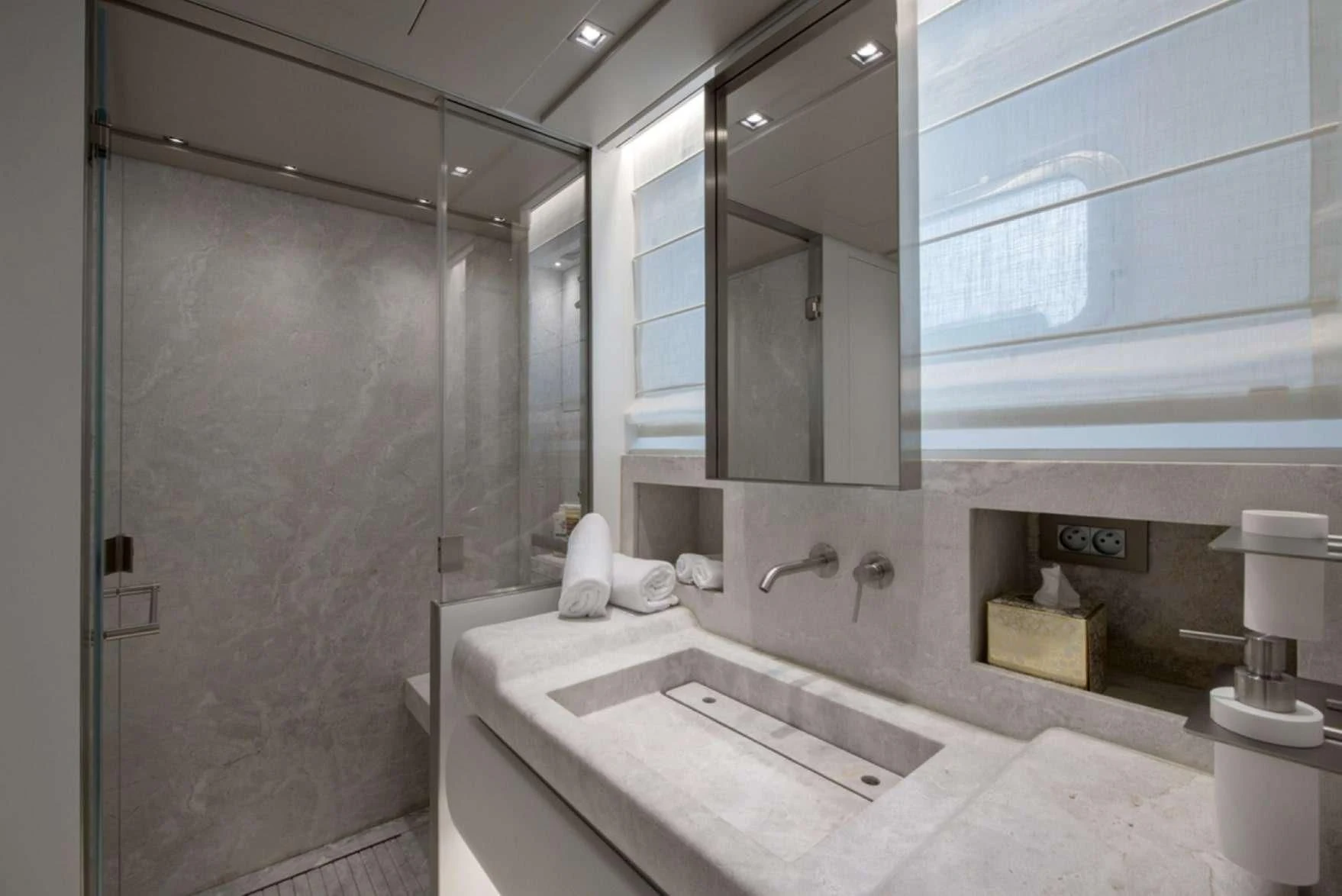 a bathroom with a bathtub and sink aboard PARALOS Yacht for Charter