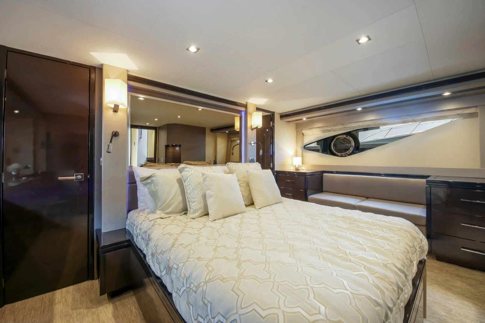 a bedroom with a bed and a mirror aboard PARALOS Yacht for Charter