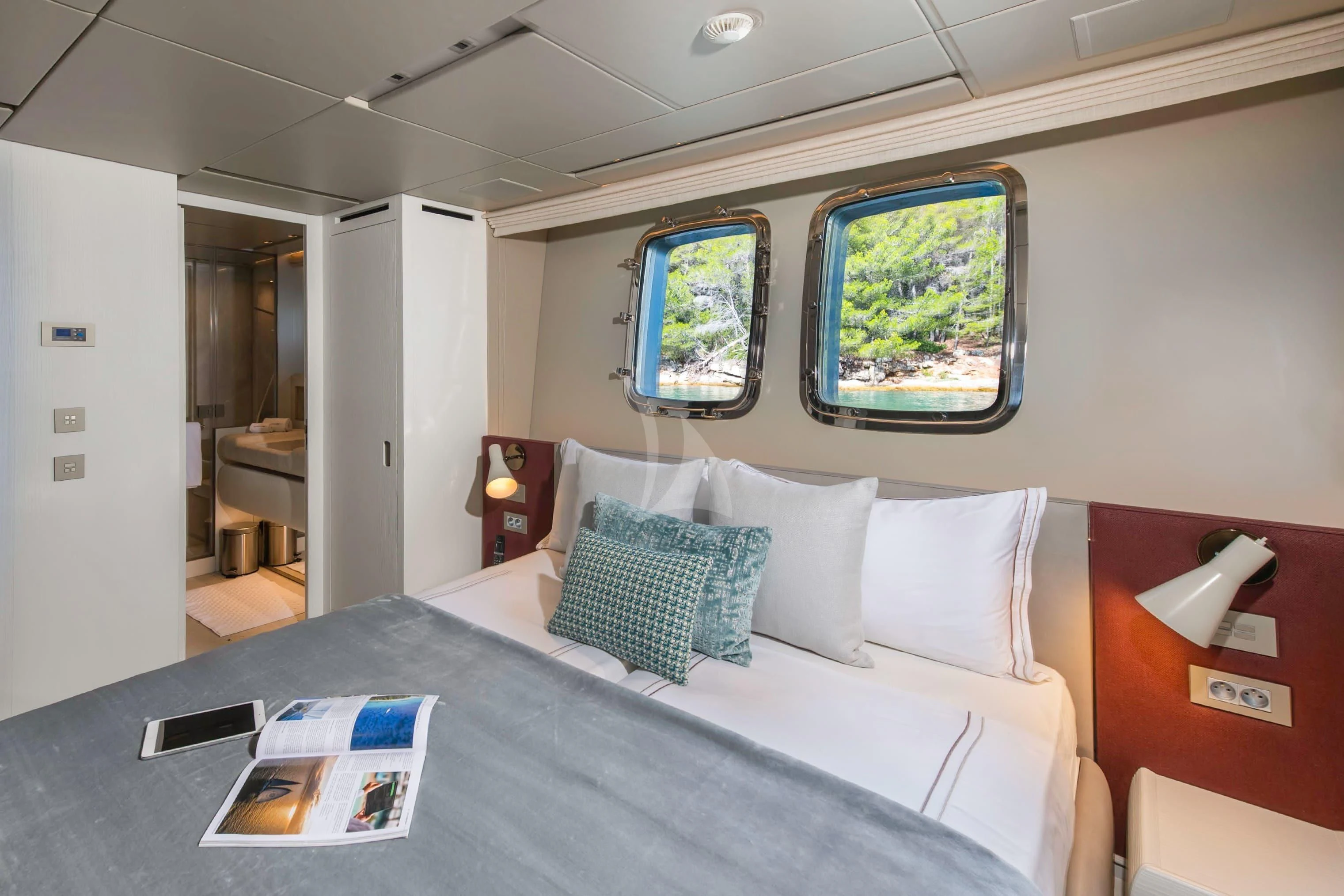 a bed with a blue tablecloth aboard PARALOS Yacht for Charter