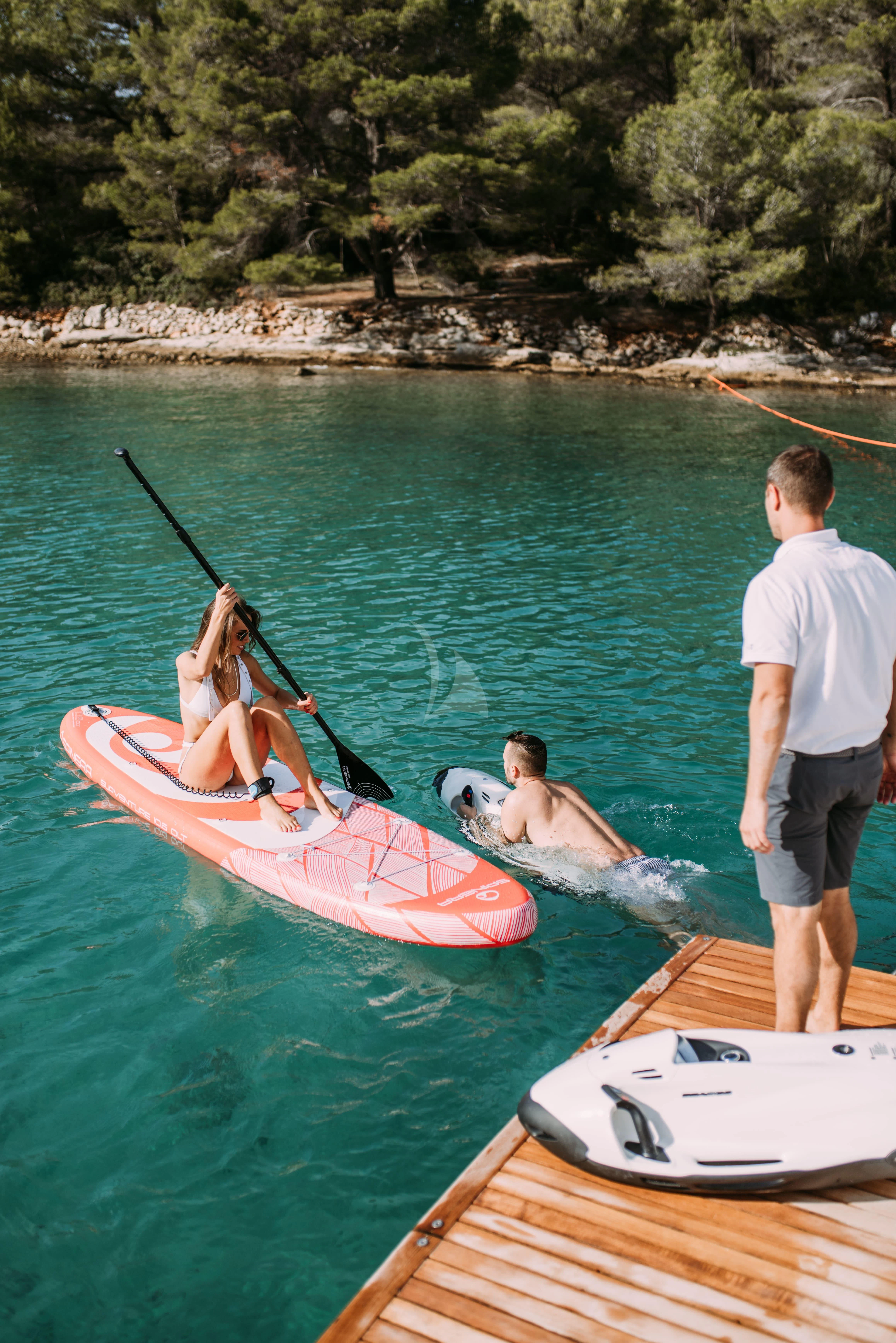 a group of people in a kayak on a lake aboard PARALOS Yacht for Charter