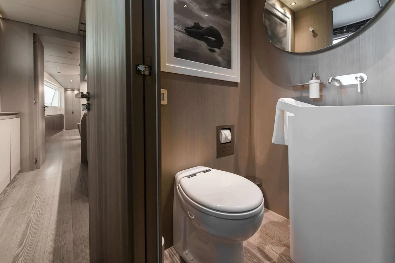 a bathroom with a toilet and a mirror aboard PARALOS Yacht for Charter