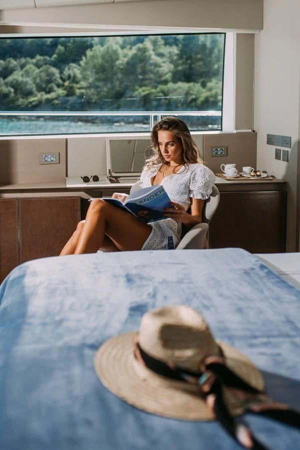a woman sitting on a couch with a child on her lap aboard PARALOS Yacht for Charter