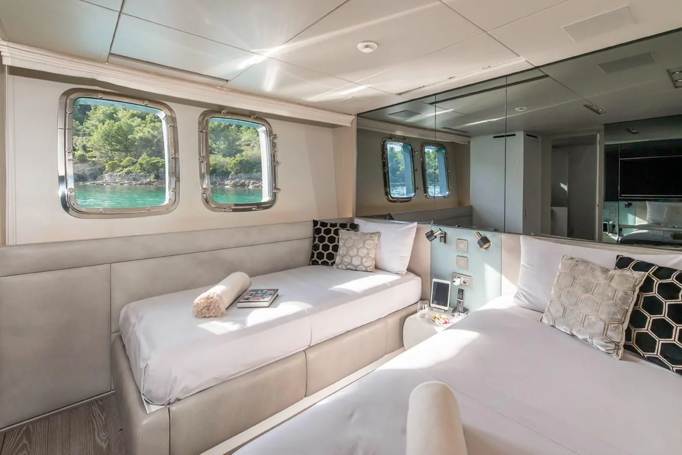 a room with a bed and a large mirror aboard PARALOS Yacht for Charter