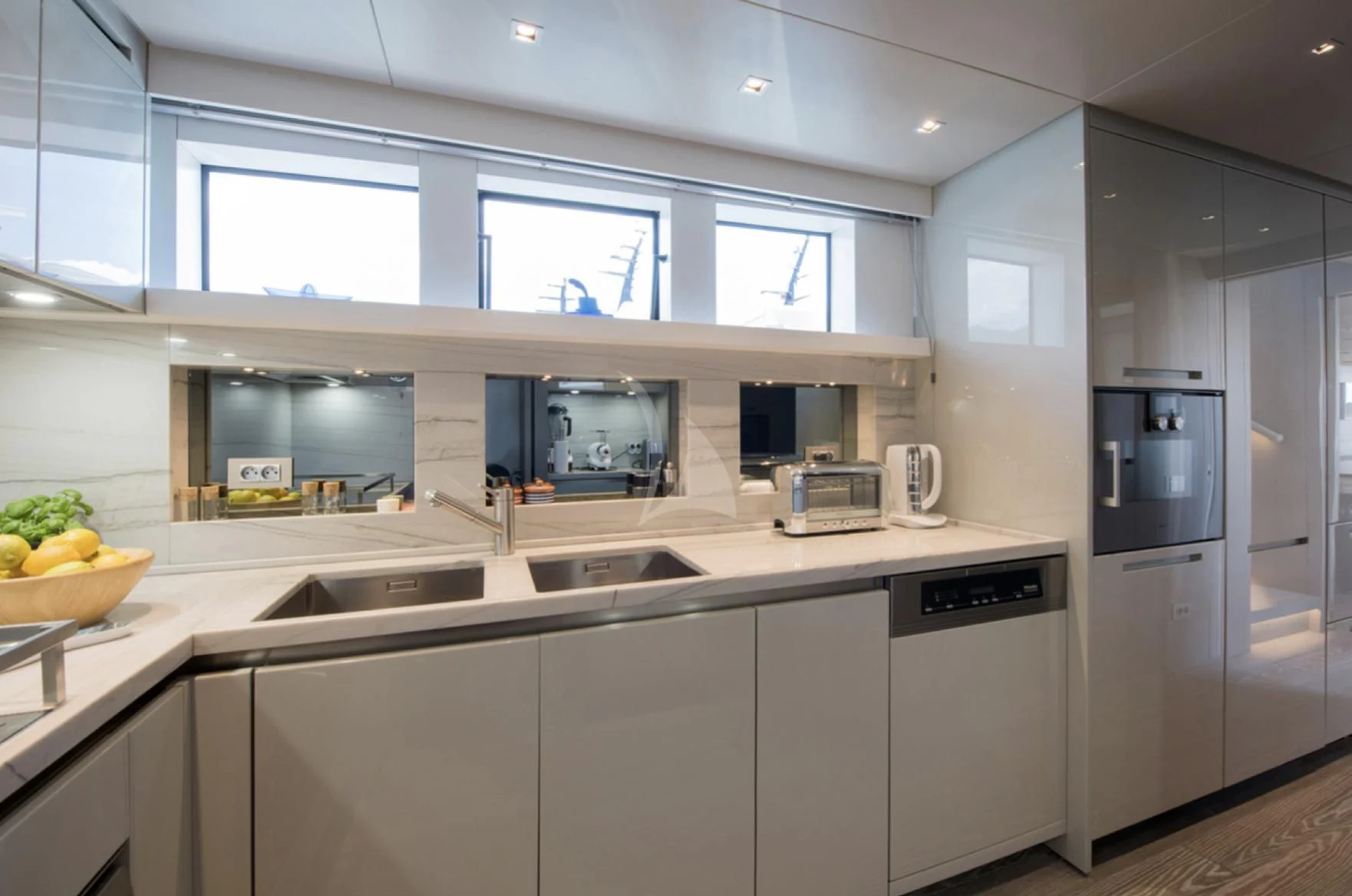 a kitchen with white cabinets aboard PARALOS Yacht for Charter