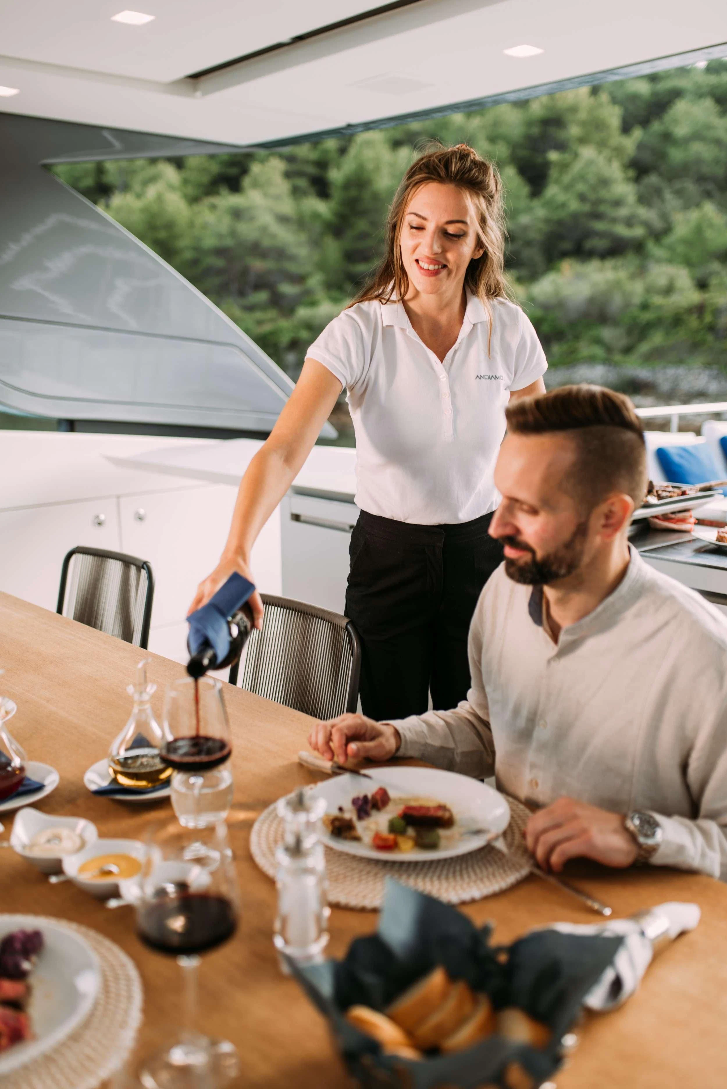 a man and a woman cutting a cake aboard PARALOS Yacht for Charter