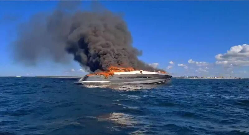 a boat on fire in the water aboard HOOLIGAN Yacht for Sale