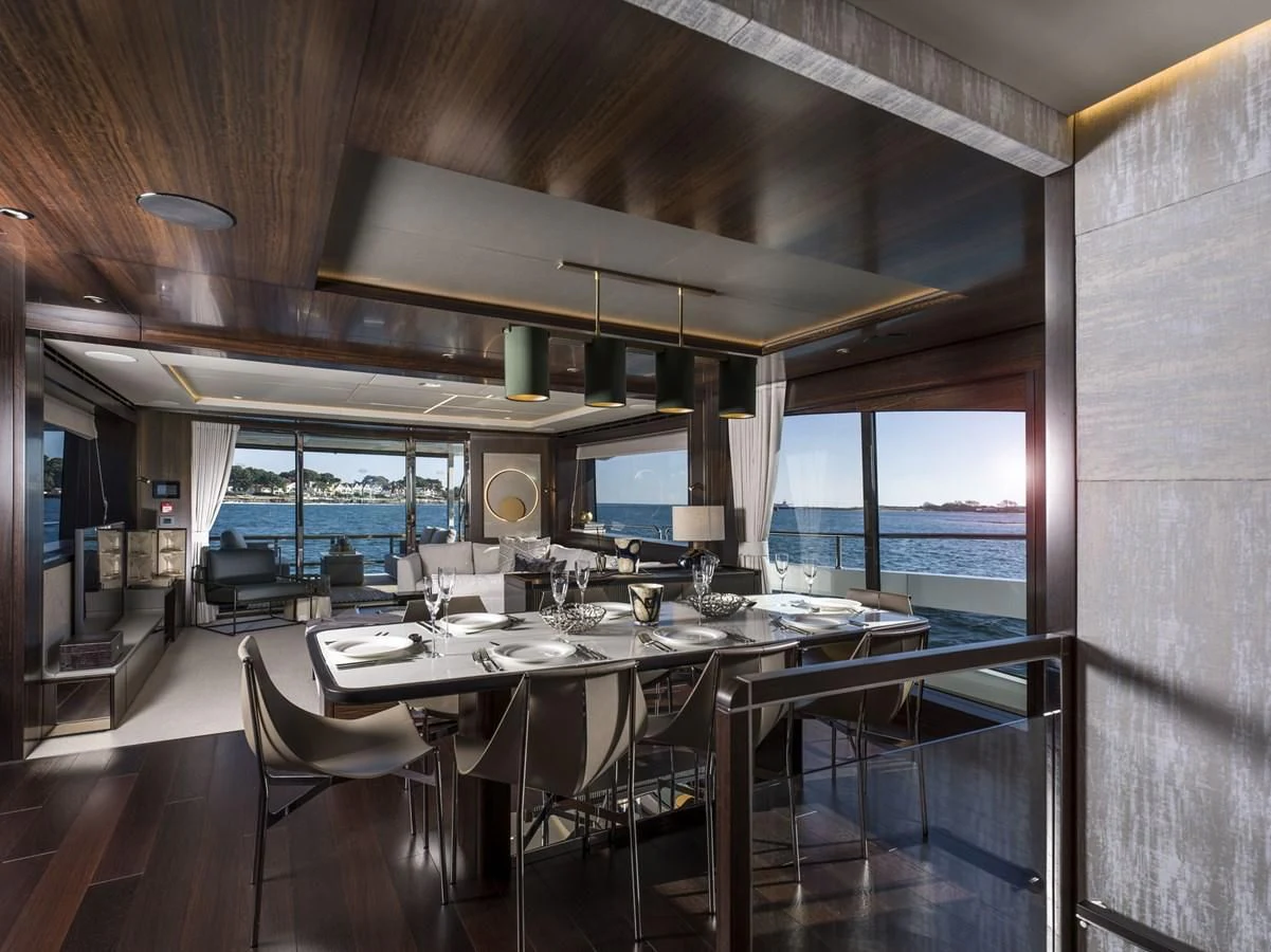 a large dining table in a room aboard MOWANA Yacht for Sale