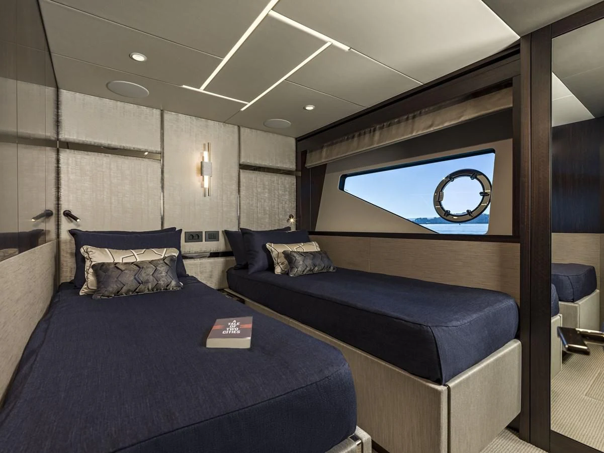 a bedroom with a blue couch aboard MOWANA Yacht for Sale