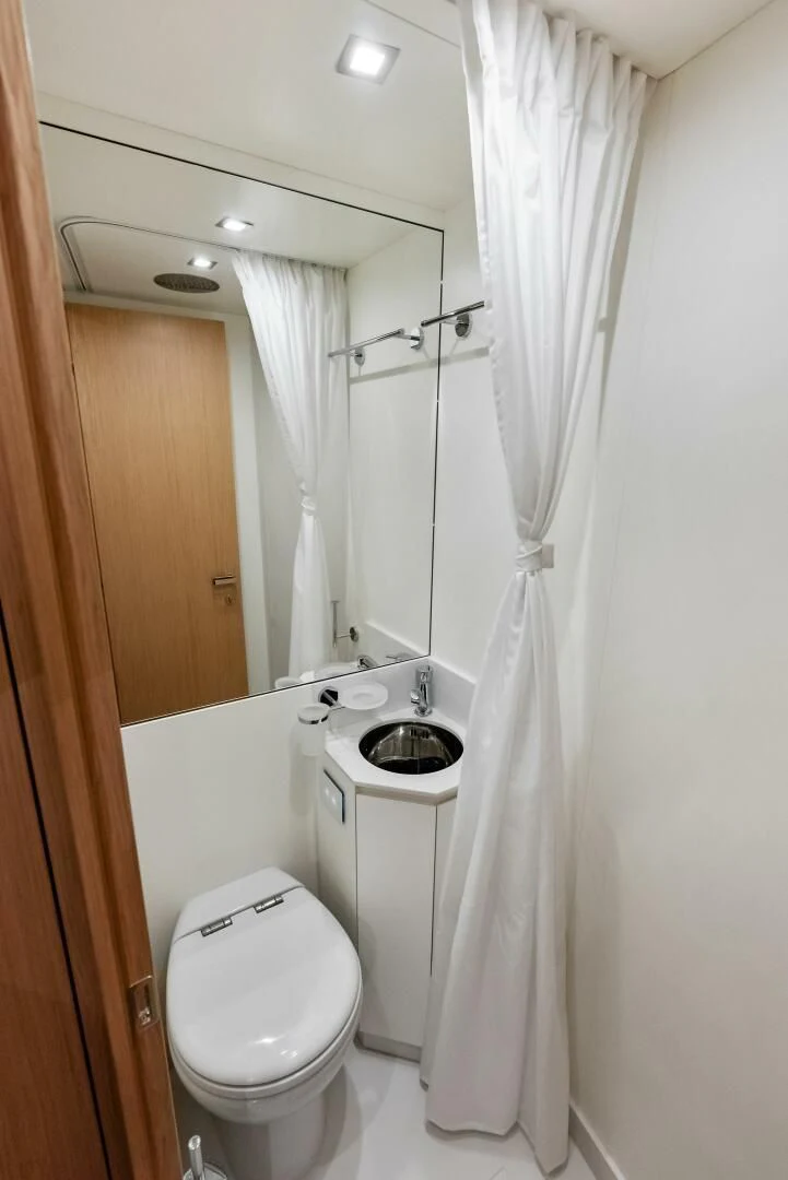 a bathroom with a toilet and sink aboard OUR TRADE Yacht for Sale