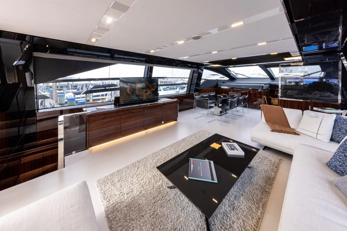 a large room with a table and couches aboard OUR TRADE Yacht for Sale
