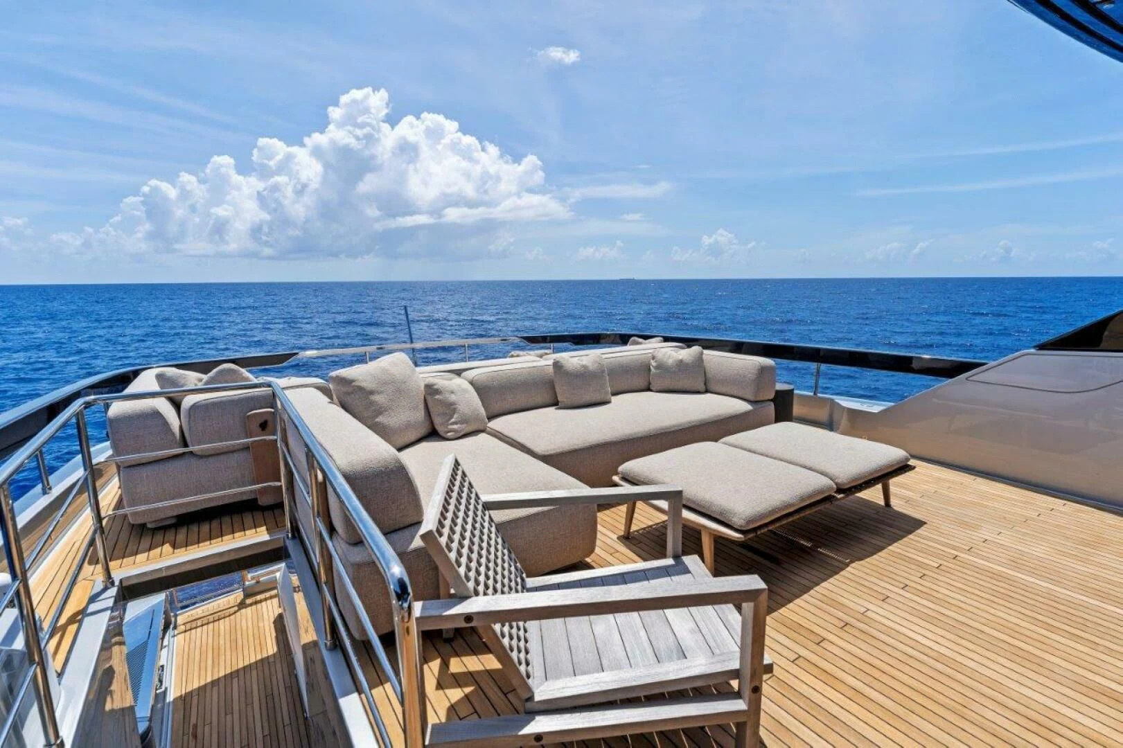 a deck with chairs on it by the ocean aboard OUR TRADE Yacht for Sale