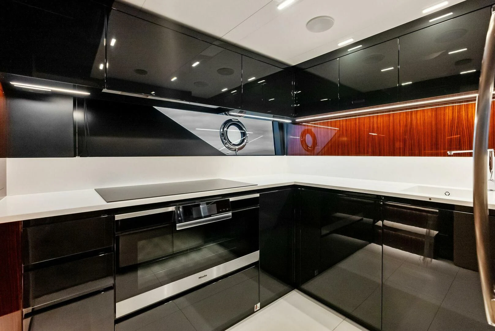 a kitchen with black and silver appliances aboard OUR TRADE Yacht for Sale