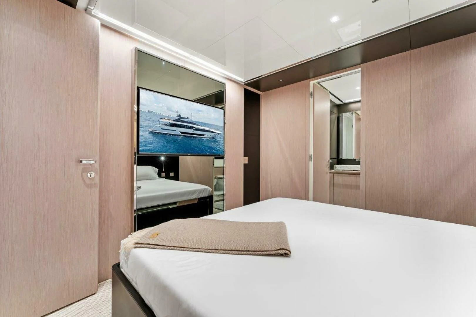 a room with a bed and a television aboard OUR TRADE Yacht for Sale
