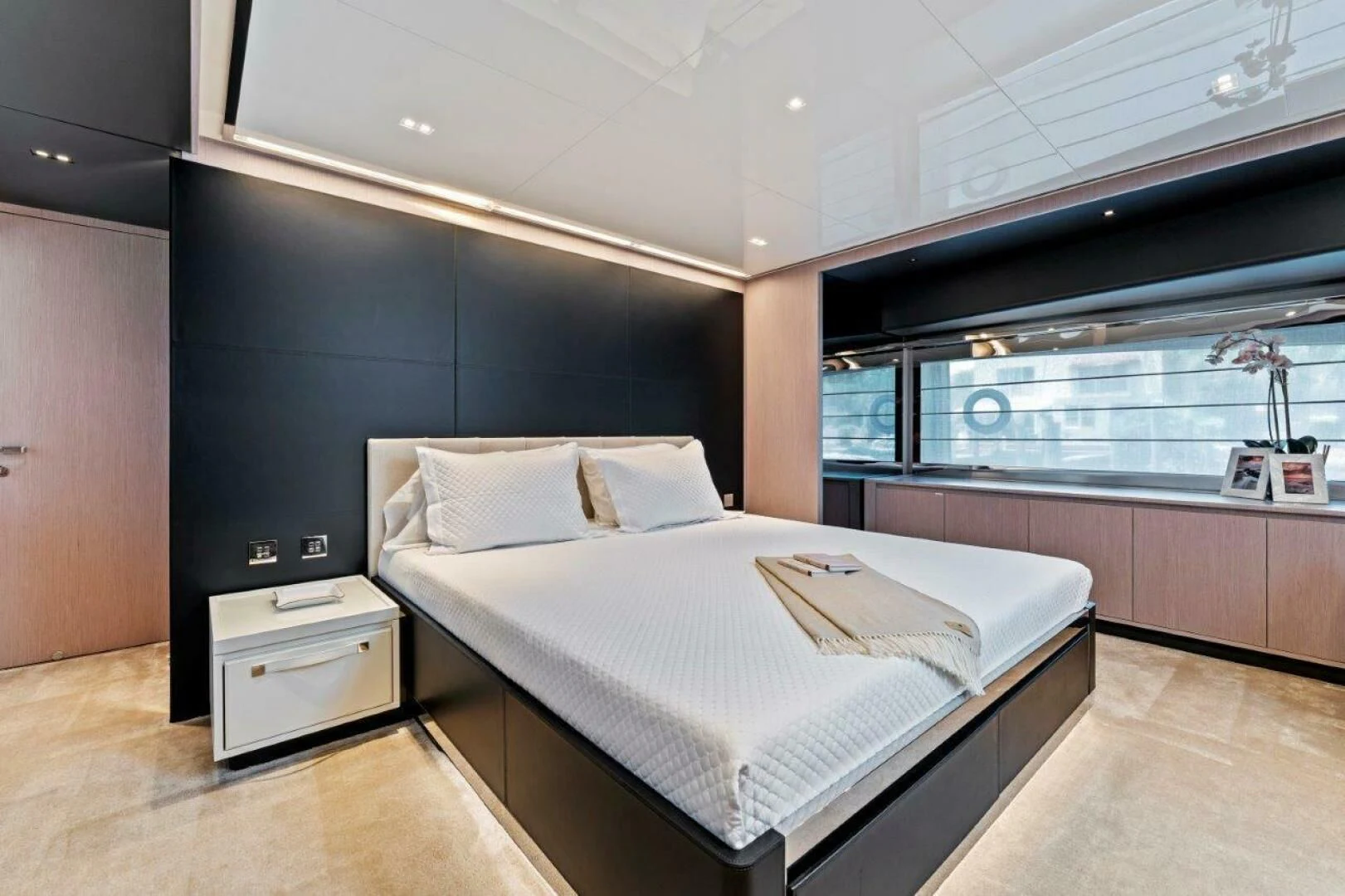 a room with a bed and a window aboard OUR TRADE Yacht for Sale
