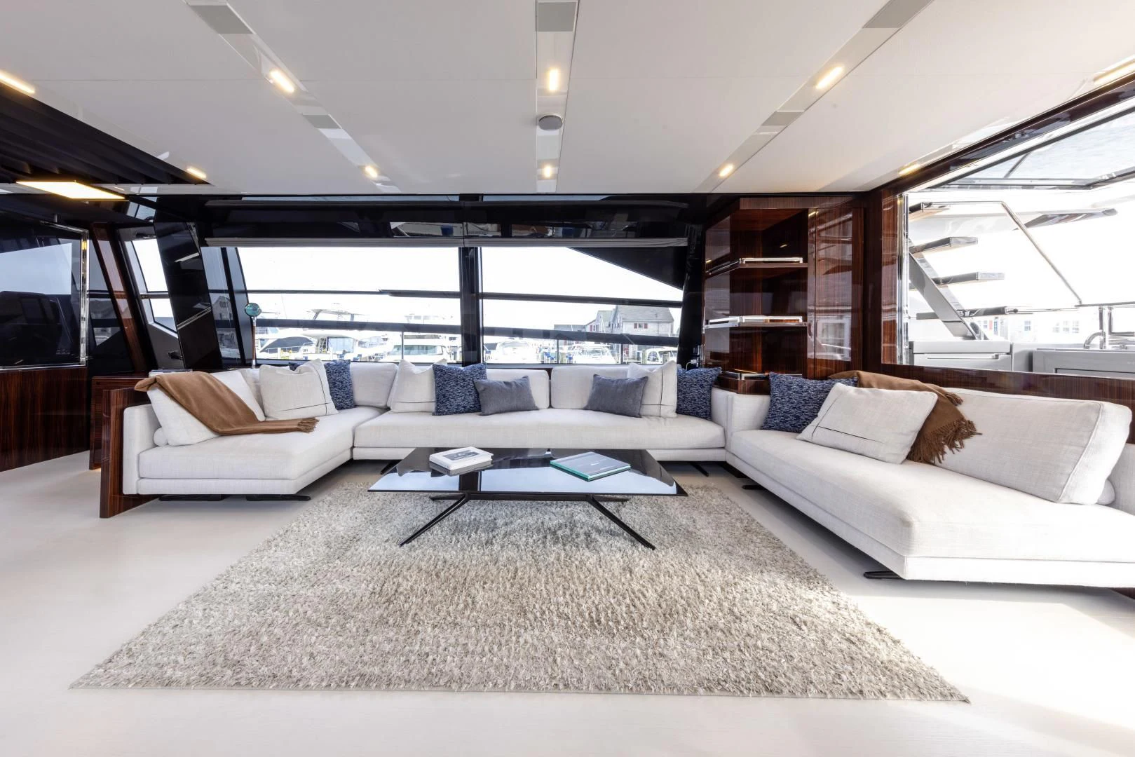 a living room with a large white couch and a large window aboard OUR TRADE Yacht for Sale