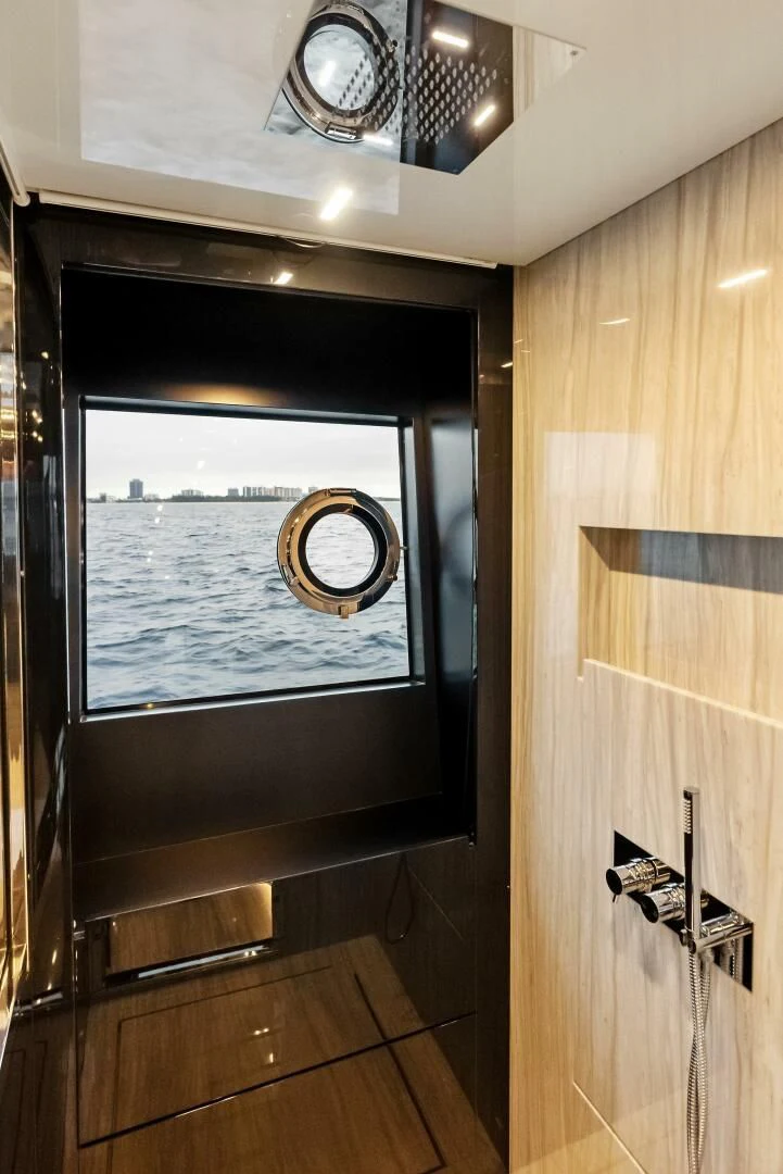 a window with a view of the water aboard OUR TRADE Yacht for Sale