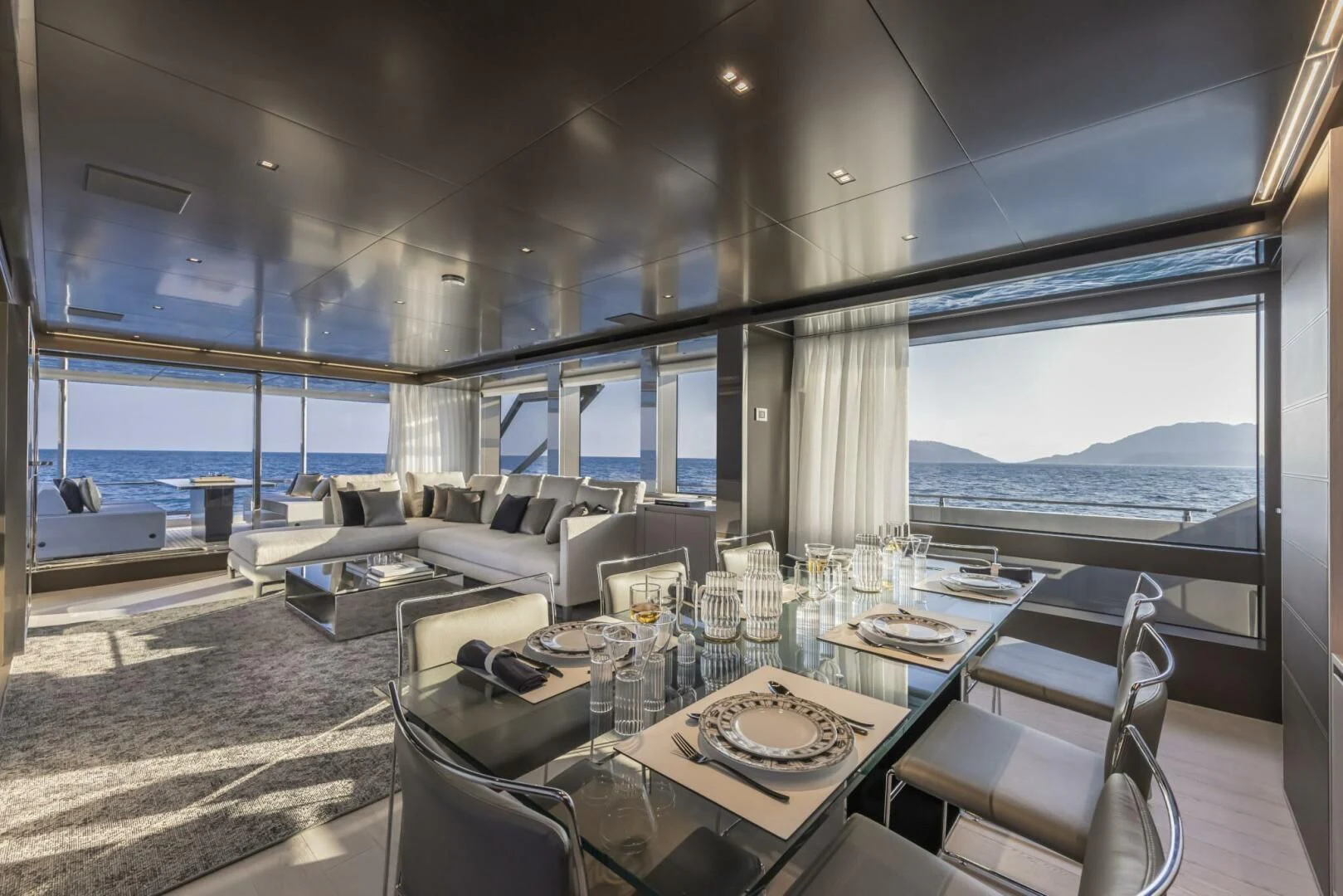 a dining room with a large window aboard OUR TRADE Yacht for Sale
