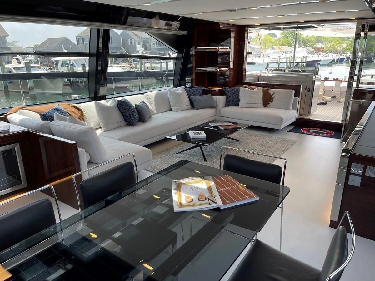 a living room with a large glass coffee table aboard OUR TRADE Yacht for Sale