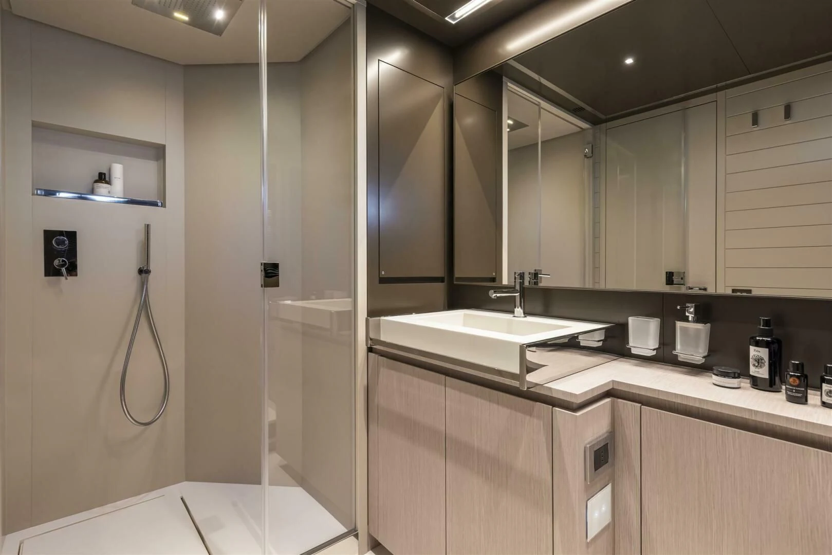 a bathroom with a shower unit and sinks aboard OUR TRADE Yacht for Sale