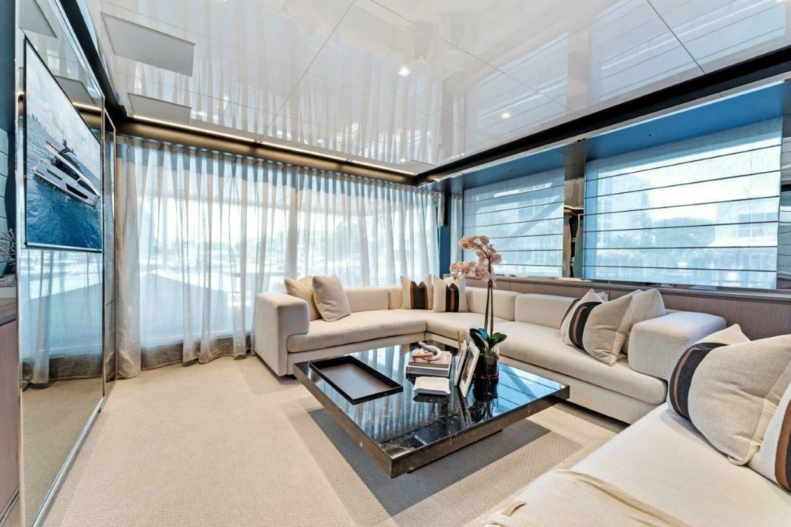 a living room with a glass coffee table and a couch aboard OUR TRADE Yacht for Sale