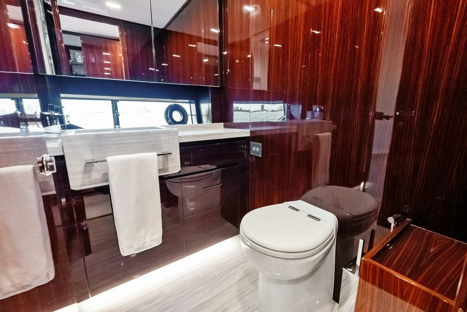 a bathroom with wooden cabinets aboard OUR TRADE Yacht for Sale