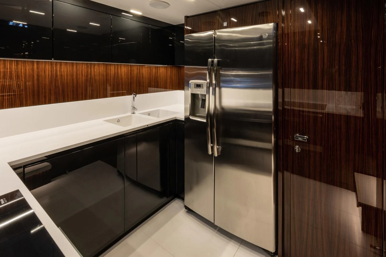 a kitchen with a stainless steel refrigerator aboard OUR TRADE Yacht for Sale