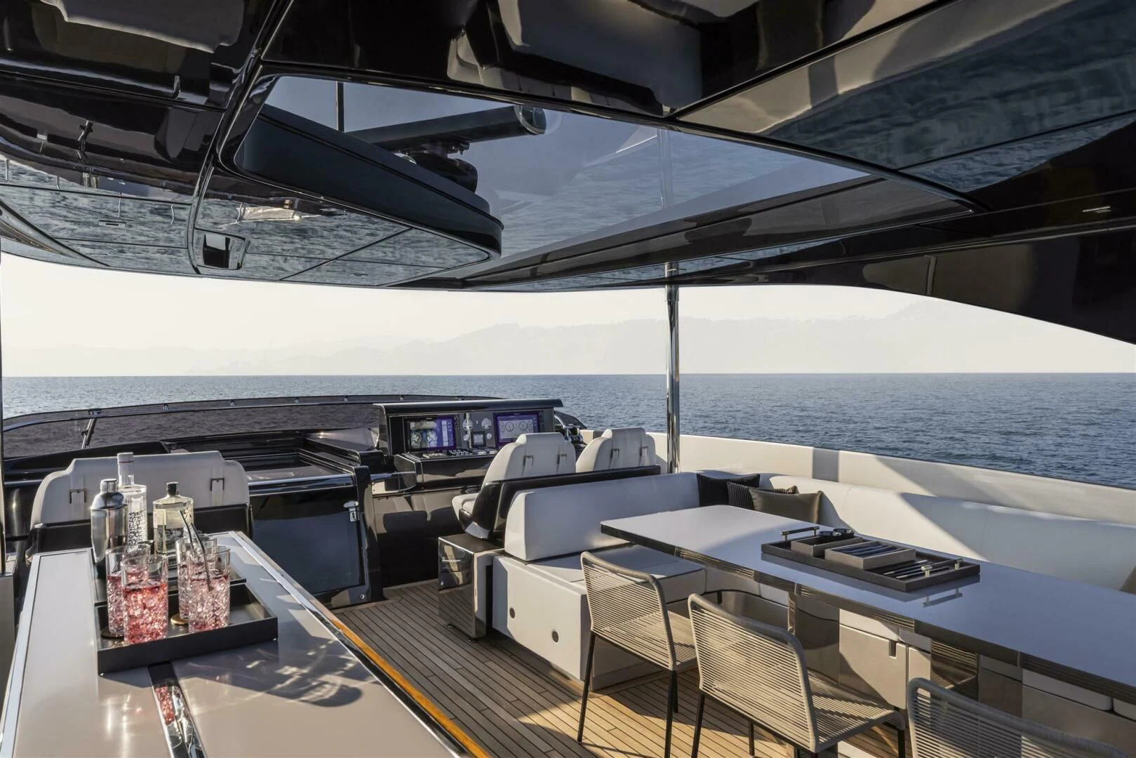 a boat with a table and chairs aboard OUR TRADE Yacht for Sale