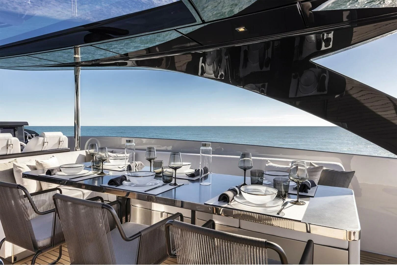 a table with wine glasses on it aboard OUR TRADE Yacht for Sale