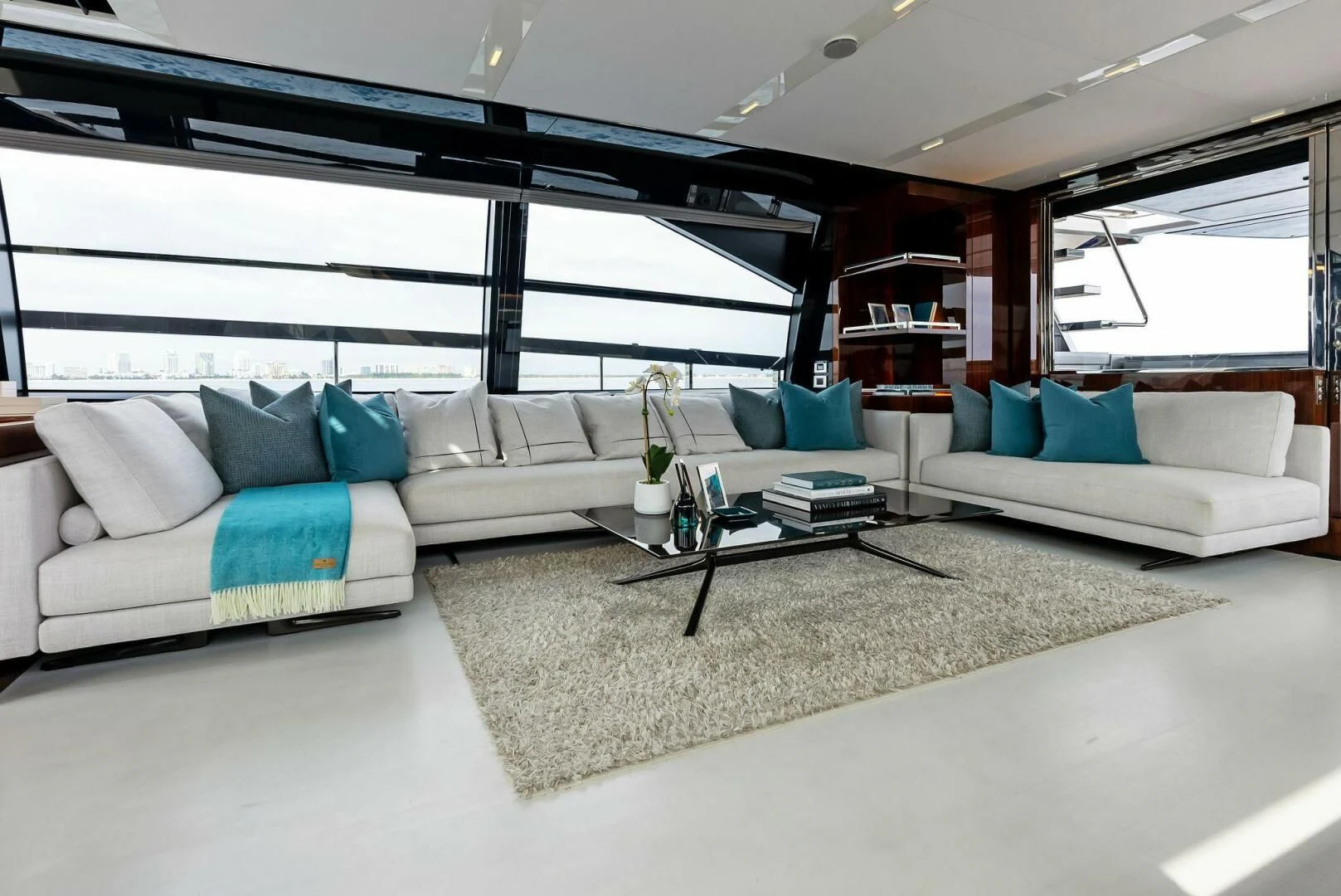 a living room with a couch and a coffee table aboard OUR TRADE Yacht for Sale