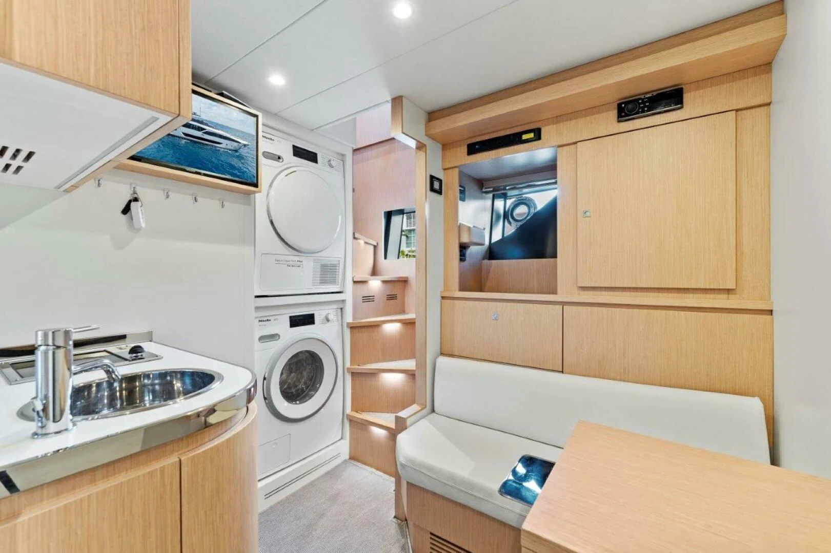 a small kitchen with a washing machine aboard OUR TRADE Yacht for Sale