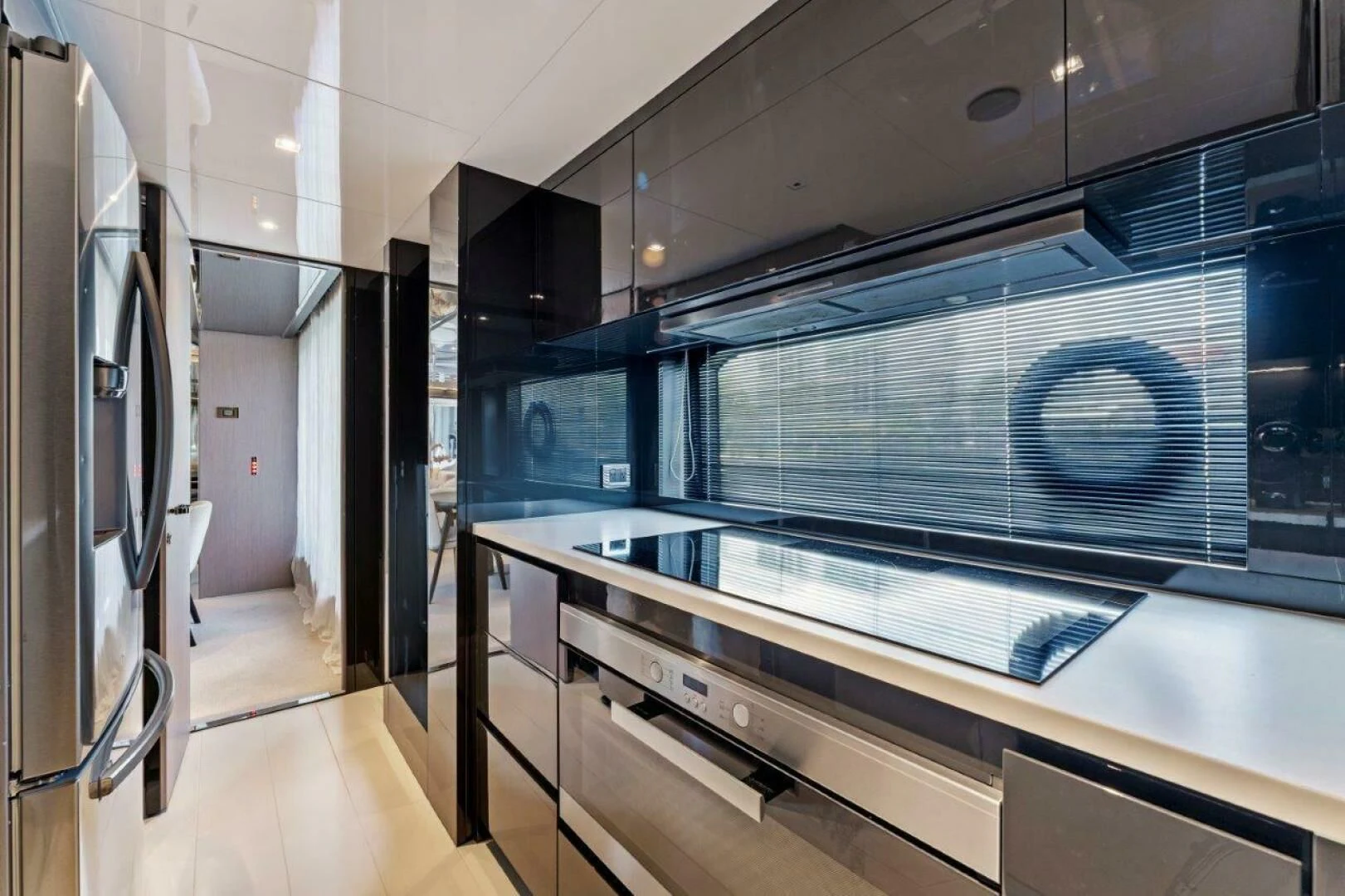 a large kitchen with a large glass wall aboard OUR TRADE Yacht for Sale