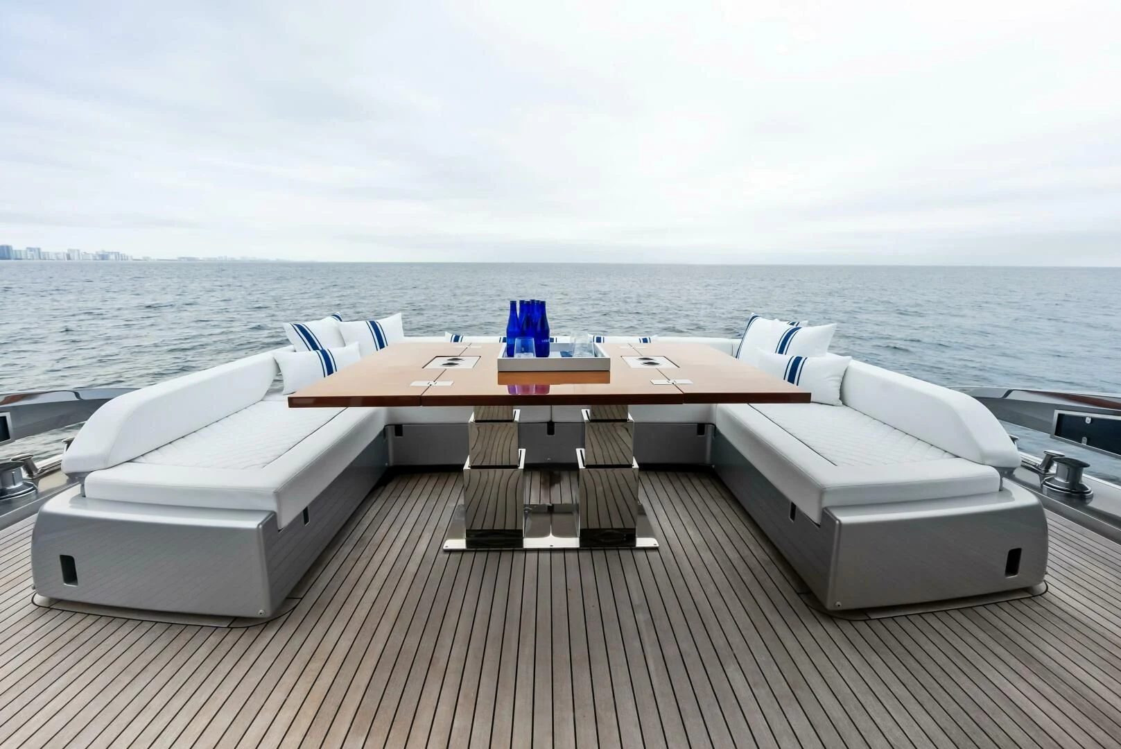 a deck with a table and chairs on it aboard OUR TRADE Yacht for Sale