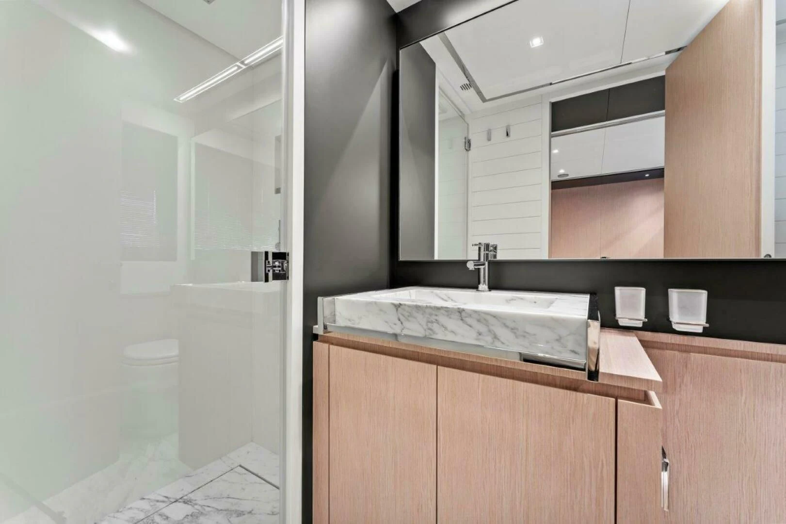 a bathroom with a sink and cabinets aboard OUR TRADE Yacht for Sale