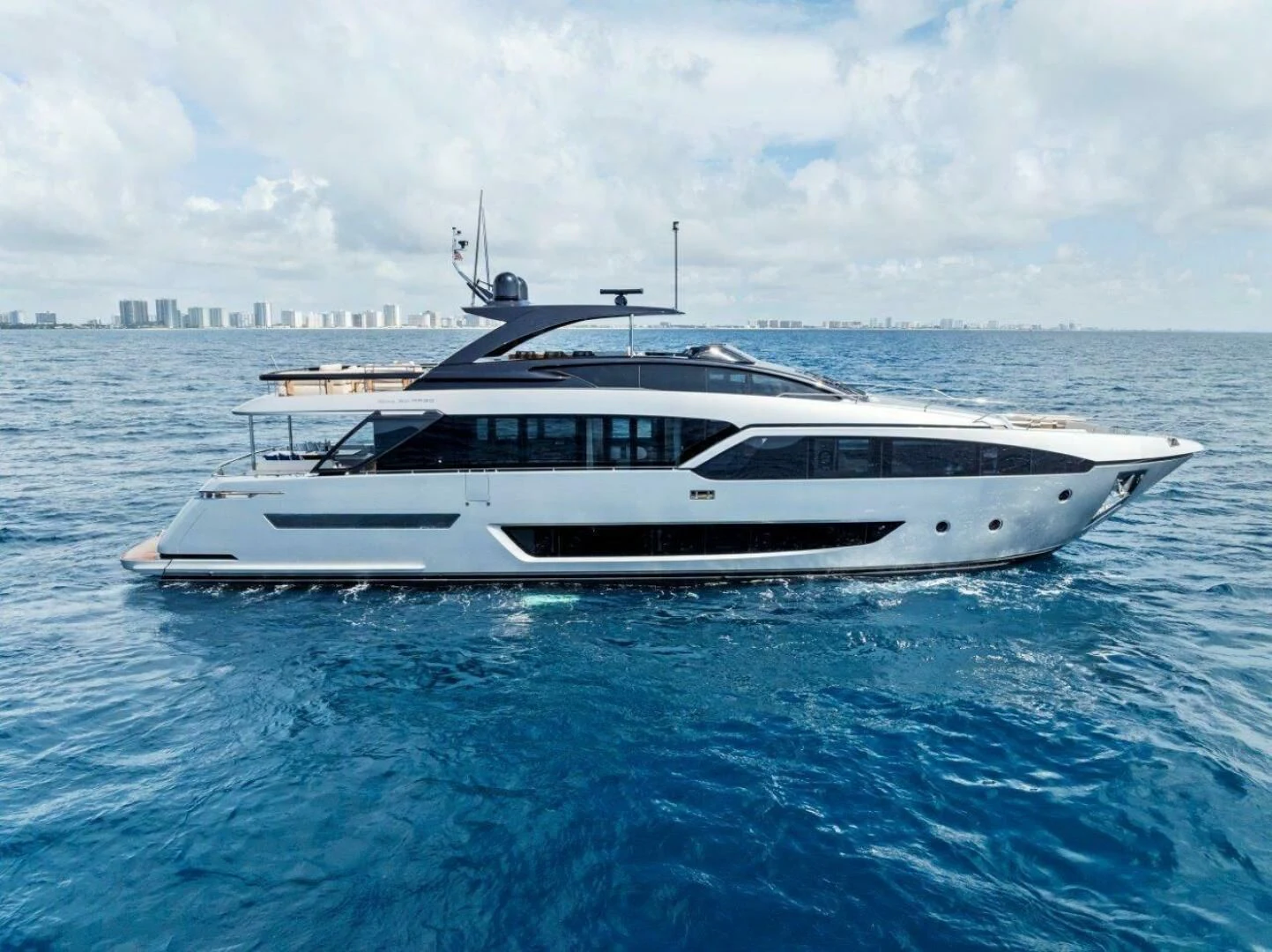 a white boat in the water aboard OUR TRADE Yacht for Sale