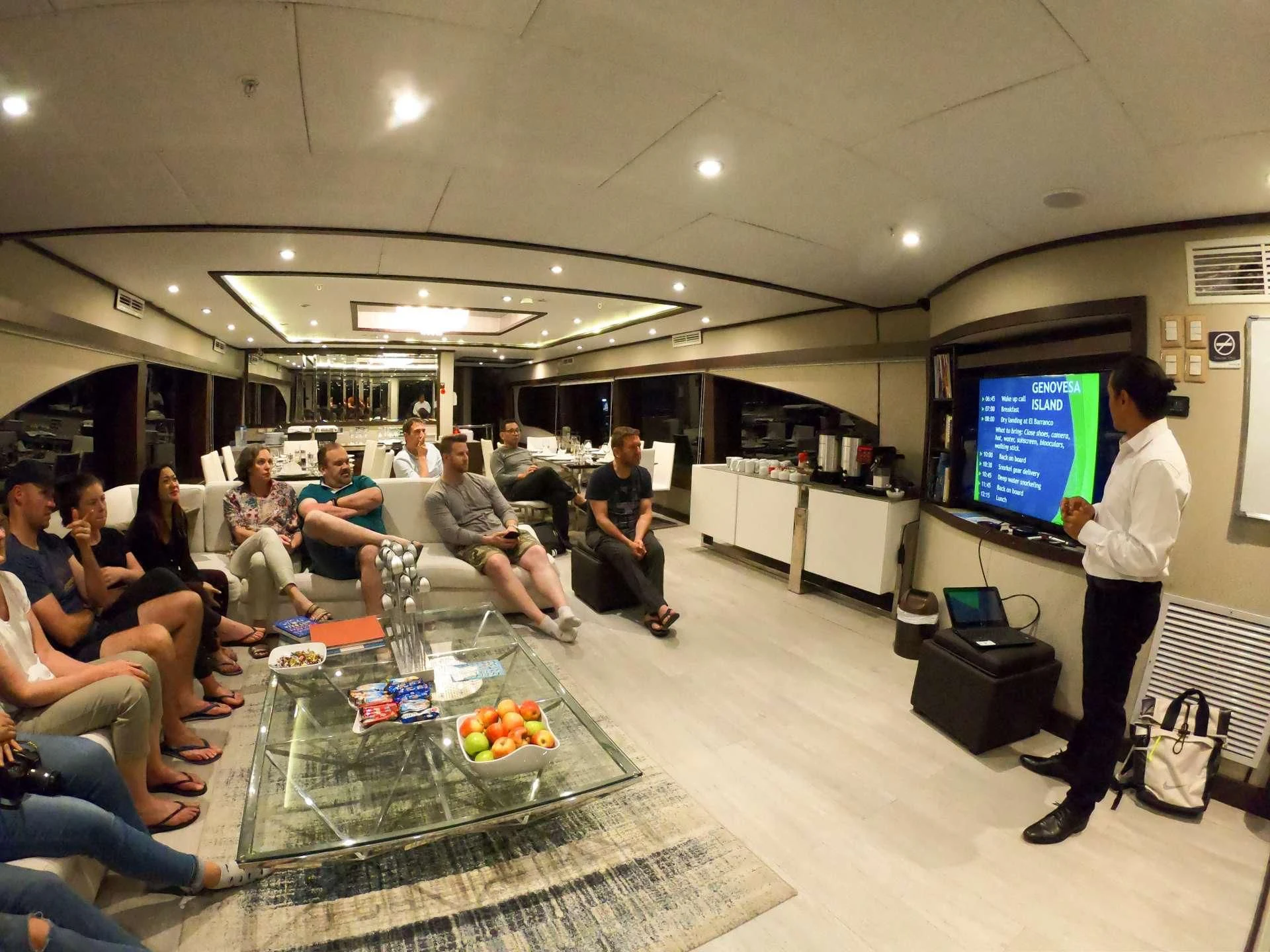 a group of people sitting in a room watching a person play a video game aboard GRAND MAJESTIC Yacht for Sale