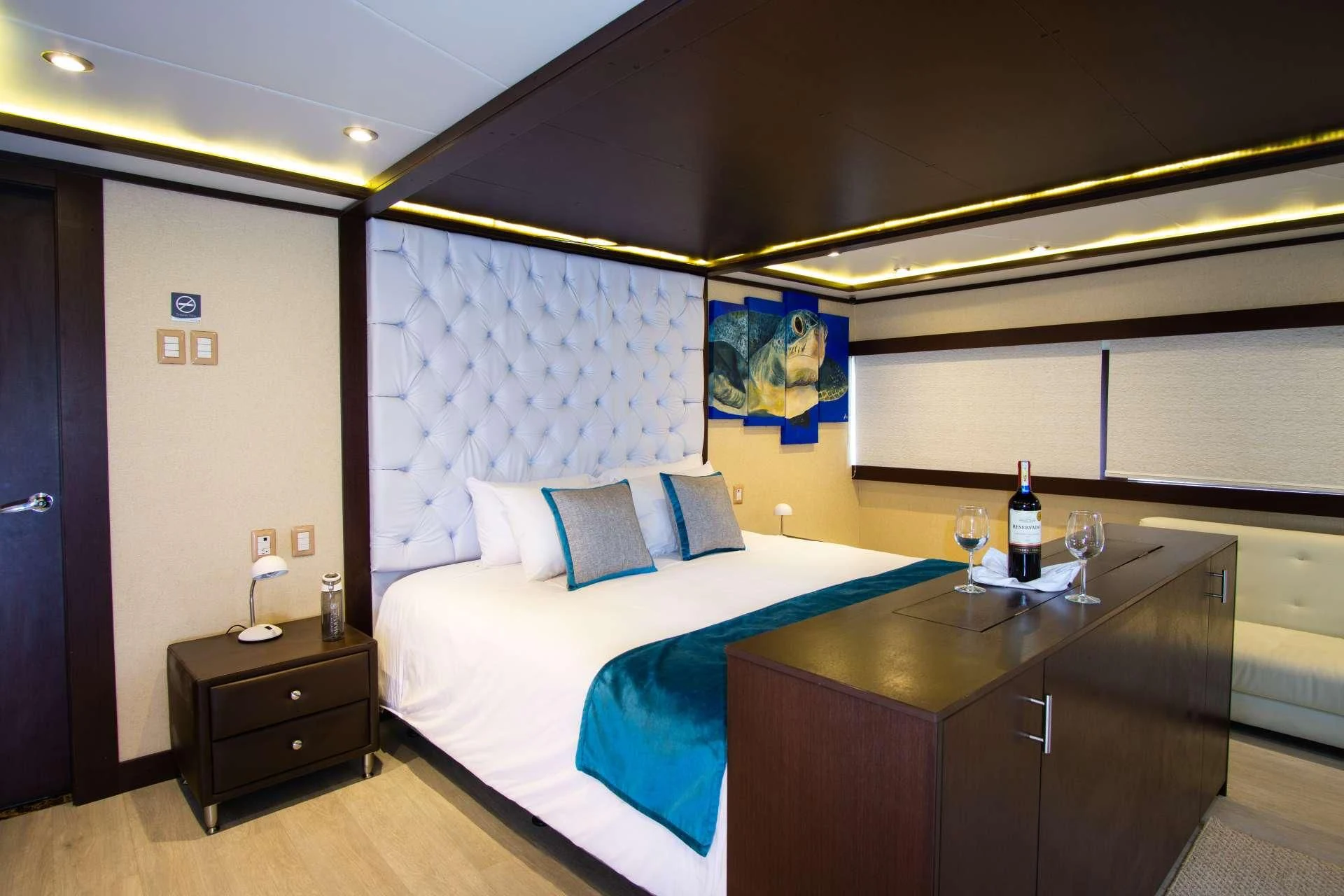 a bed with a blue sheet aboard GRAND MAJESTIC Yacht for Sale
