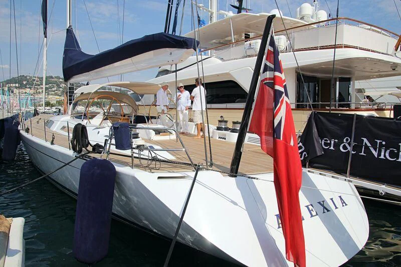 a boat with a red and white flag on it aboard ALEXIA Yacht for Sale