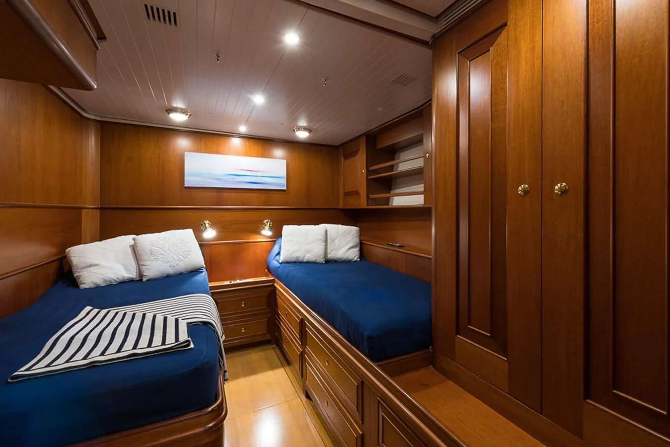 a room with a bed and a wood cabinet aboard ALEXIA Yacht for Sale