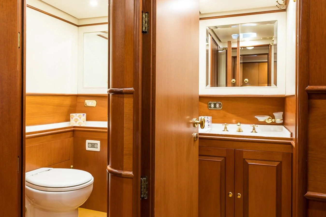 a bathroom with a toilet and a mirror aboard ALEXIA Yacht for Sale