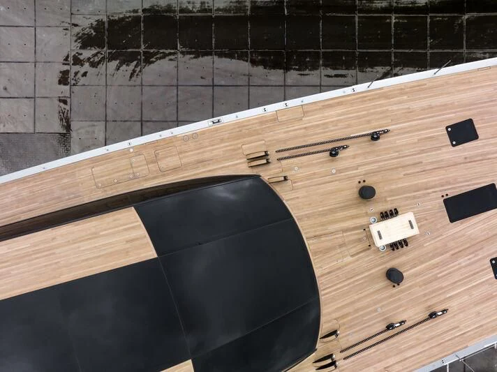 a black guitar on a wooden surface aboard SARISSA Yacht for Sale