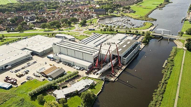 a large building with a red and white roof and a parking lot aboard SARISSA Yacht for Sale