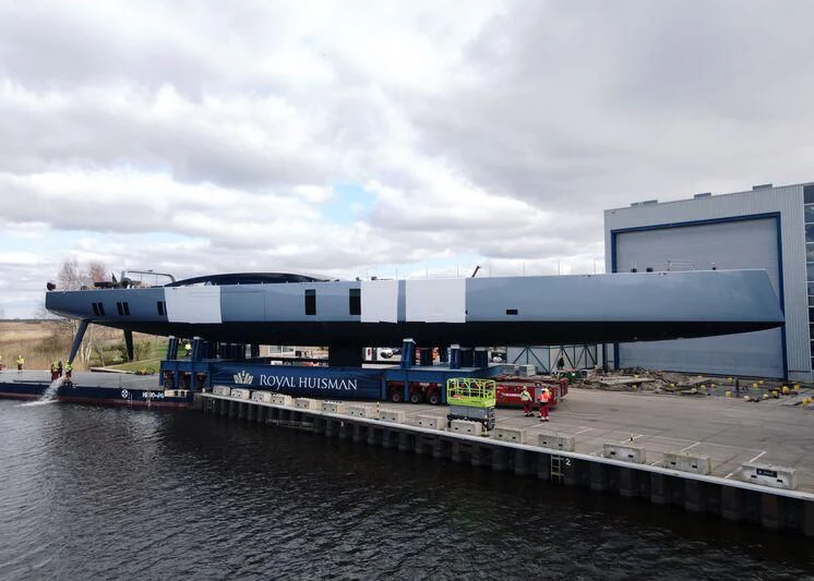 a container ship docked at a port aboard SARISSA Yacht for Sale
