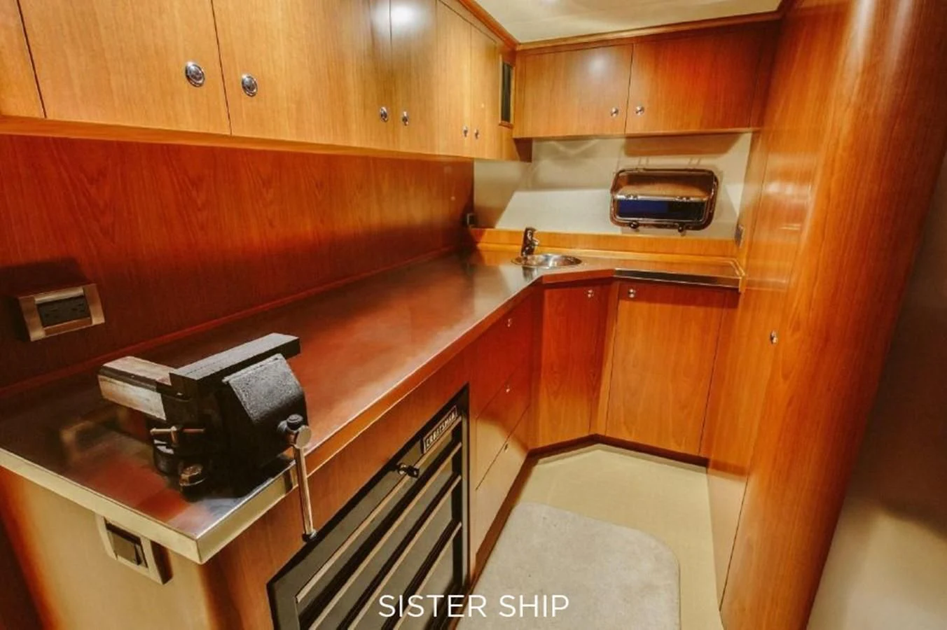 a kitchen with wooden cabinets aboard 880 CPMY Yacht for Sale