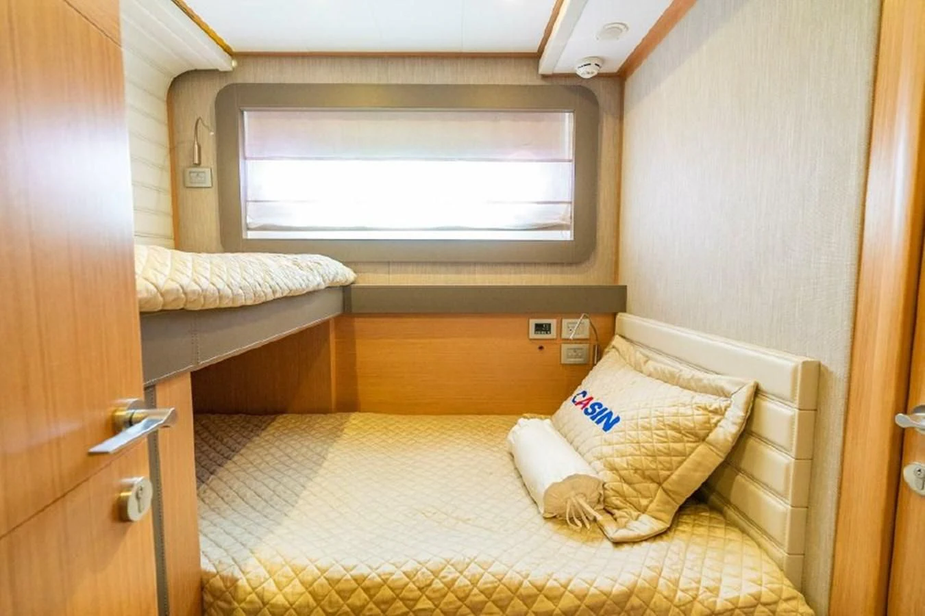 a bed with a white pillow aboard FERRETTI Yacht for Sale