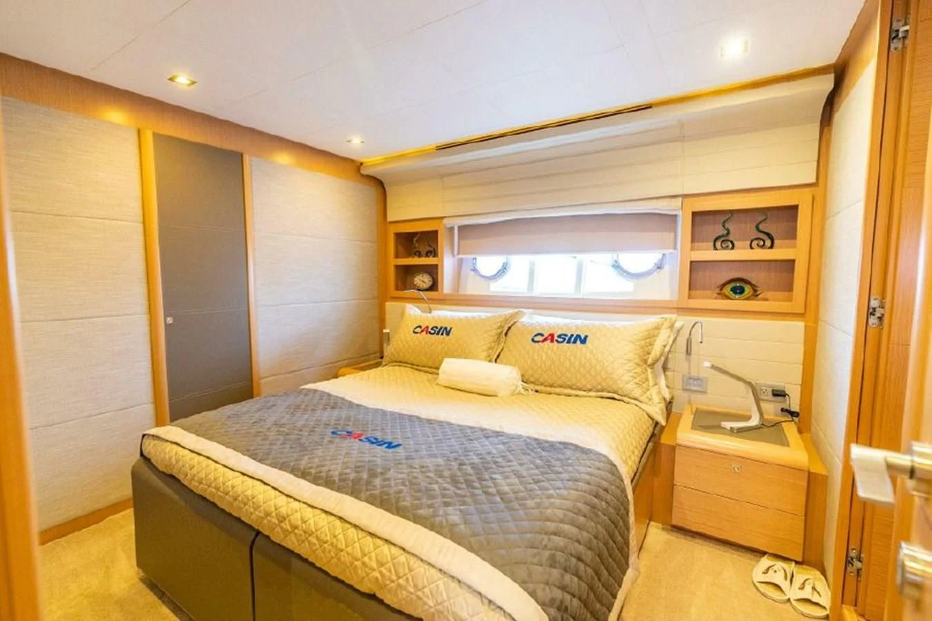 a bedroom with a bed and a window aboard FERRETTI Yacht for Sale