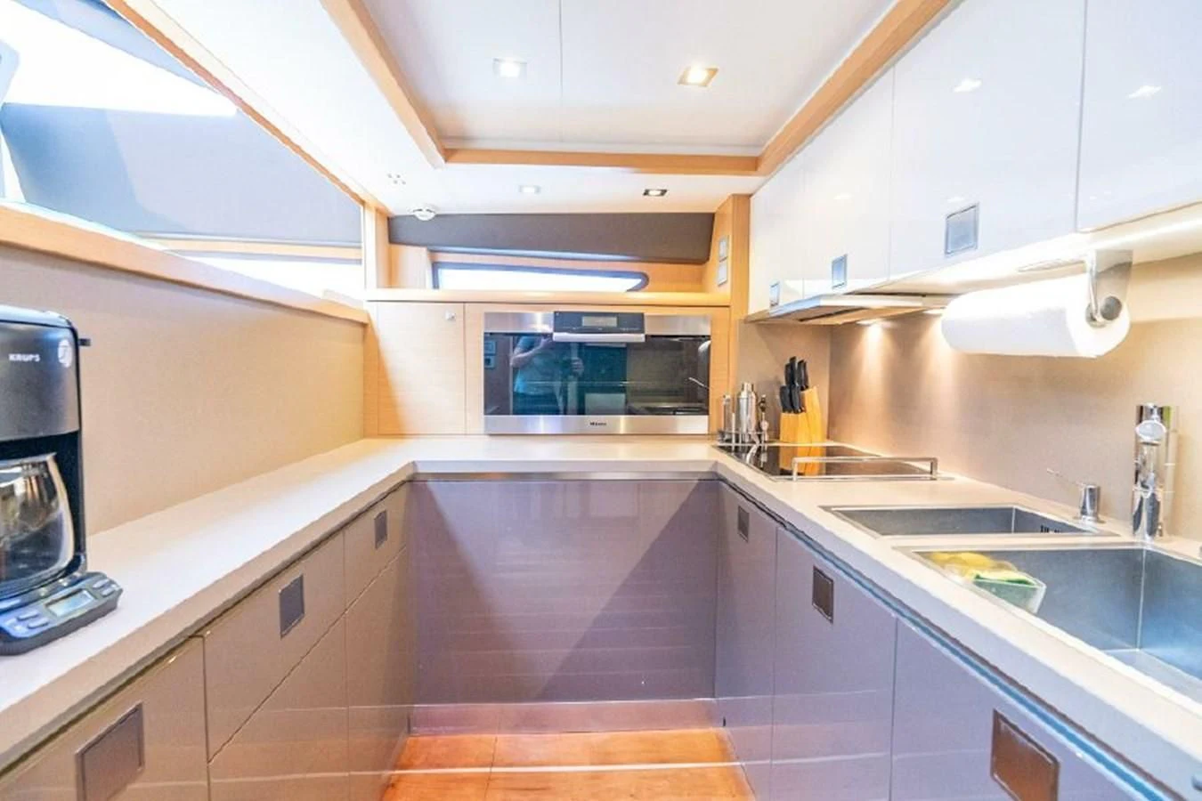 a kitchen with a sink and cabinets aboard FERRETTI Yacht for Sale