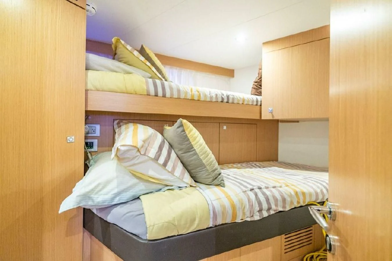 a couple of beds in a room aboard FERRETTI Yacht for Sale